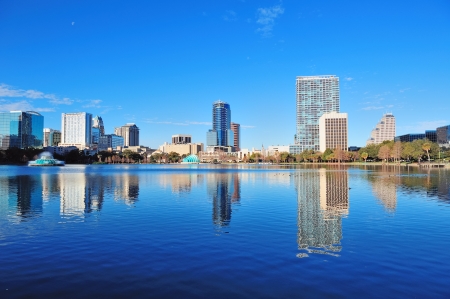 Orlando Lake Eola in the morning with urban skyscrapers and clear blue sky.の写真素材