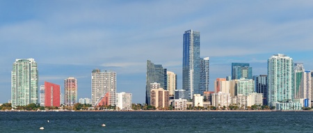 Miami skyline panorama in the day with urban skyscrapers and cloudy sky over sea の写真素材