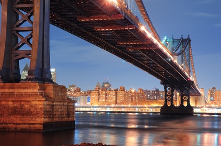 New York City Manhattan Bridge closeup with downtown skyline over East River.