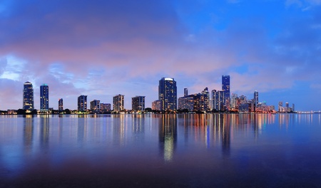 Miami city skyline panorama at dusk with urban skyscrapers over sea with reflectionのeditorial素材