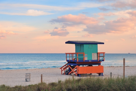 Miami South Beach sunset with lifeguard tower and coastline with colorful cloud and blue sky.の写真素材