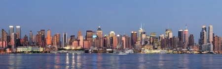 Hudson River waterfront view of New York City Manhattan after sunset with cityscape panorama and light reflection in tranquil blue tone のeditorial素材