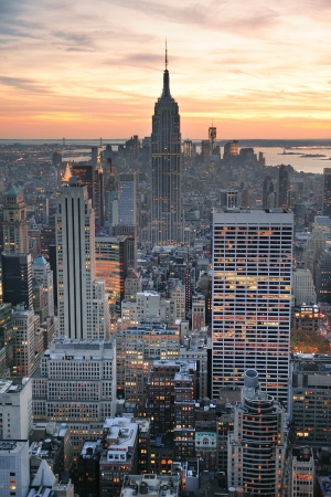 New York City skyline aerial view at sunset with colorful cloud and skyscrapers of midtown Manhattan.の写真素材