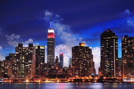 New York City Manhattan midtown panorama at dusk with skyscrapers illuminated over east riverの写真素材