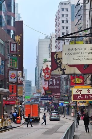 HONG KONG, CHINA - APR 23  Street view with traffic and shops on April 23, 2012 in Hong Kong, China  With 7M population and land mass of 1104 sq km, it is one of the most dense areas in the world のeditorial素材
