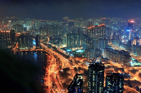 Victoria Harbor aerial view with Hong Kong skyline and urban skyscrapers at night の写真素材