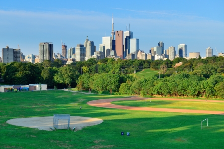 Toronto skyline over park with urban buildings and blue skyのeditorial素材