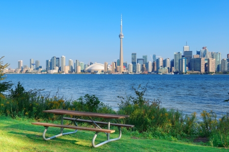 Toronto skyline in the day over lake with urban architecture viewed from parkの写真素材