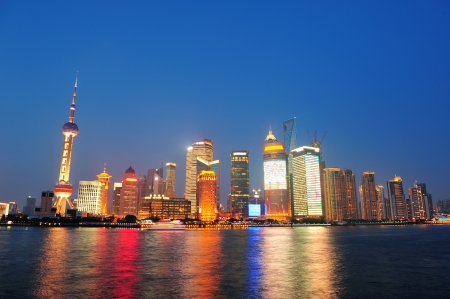 Urban skyscrapers in Shanghai at night over riverのeditorial素材