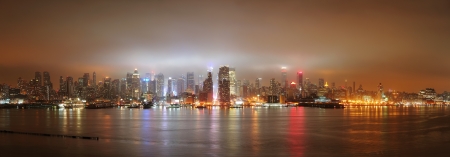 New York City Manhattan midtown panorama skyline at night with skyscrapers over Hudson River viewed from New Jersey.の写真素材