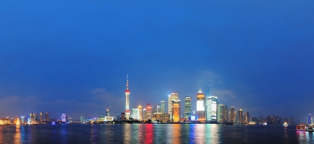 Urban skyscrapers in Shanghai at night over riverのeditorial素材