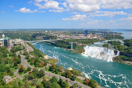 Rainbow Bridge and American Falls over river with blue skyの写真素材