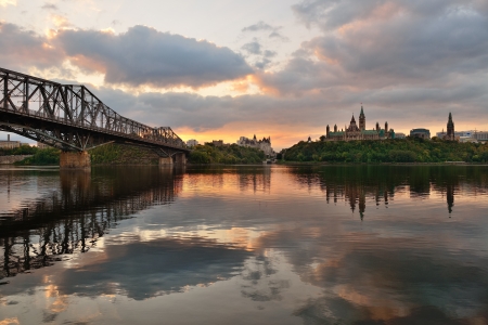 Ottawa city skyline at sunrise in the morning over river with urban historical buildings and colorful cloudの写真素材