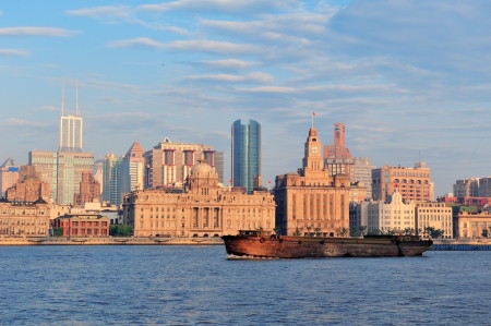 Shanghai historic and urban buildings over Huangpu River in the morning with blue sky and boat.の写真素材