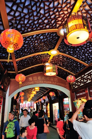 SHANGHAI, CHINA - MAY 30: Chenghuangmiao street with crowded stores and decorations on May 30, 2012 in Shanghai. It is the largest city by population in the world with 23 million in 2010のeditorial素材