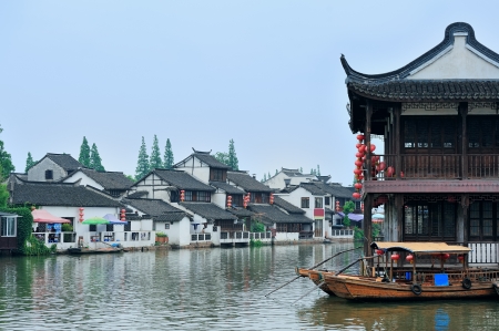 Old village by river in Shanghai with boatの写真素材