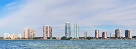 Miami skyline panorama in the day with urban skyscrapers and cloudy sky over sea の写真素材