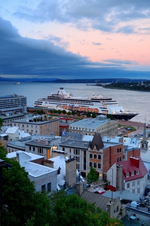 Cruise ship and lower town old buildings at sunset in Quebec City.の写真素材