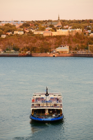 Ferry boat in river in Quebec City at sunset.のeditorial素材