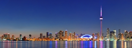 Toronto cityscape panorama at dusk over lake with colorful light.の写真素材