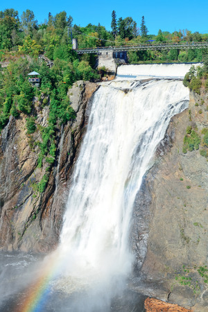 Montmorency Falls with rainbow and blue sky near Quebec City の写真素材