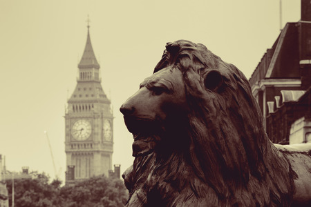 Trafalgar Square lion statue and Big Ben in London in BW