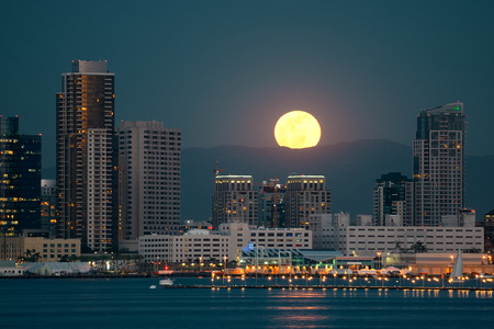 San Diego downtown skyline and full moon over water at nightの写真素材