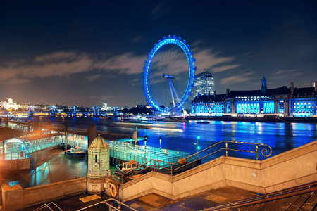 LONDON, UK - SEP 26: London Eye over Thames River at night on September 26, 2013 in London, UK. It is Europe's tallest Ferris wheel and the most popular paid tourist attraction in UKのeditorial素材