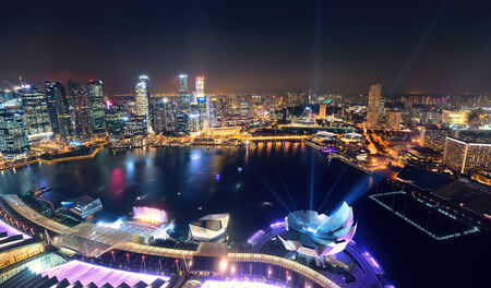 Singapore Marina Bay rooftop view with urban skyscrapers at night.のeditorial素材