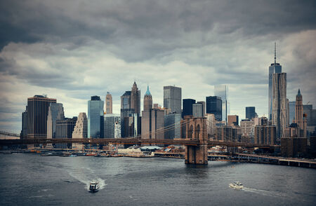 Manhattan financial district with skyscrapers and Brooklyn Bridge.の写真素材