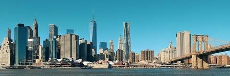 Manhattan financial district with skyscrapers and Brooklyn Bridge.の写真素材