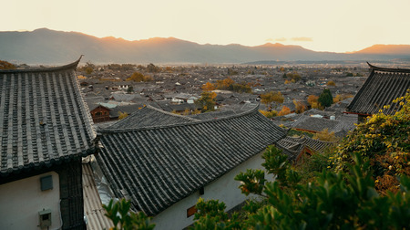 Lijiang Old Town mountain top view at sunrise with local historical architecturesの写真素材
