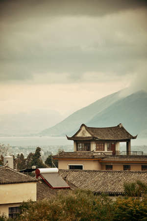 Dali Old Town with misty mountain and historical buildings in Yunnan, China.の写真素材
