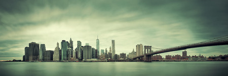 Manhattan financial district with skyscrapers and Brooklyn Bridge.の写真素材