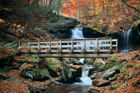 Autumn waterfalls in park with colorful foliage.の写真素材