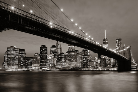 Manhattan Downtown urban view with Brooklyn bridge at nightの写真素材
