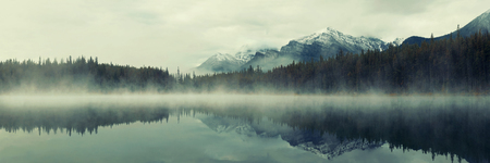 Lake Herbert panorama in a foggy morning with glaciers mountain and reflection in Banff National Park, Canadaの写真素材