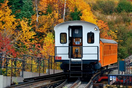 MT Washington, NEW HAMPSHIRE - OCT 13: Tourism train at mountain range with foliage on October 13, 2015 in New Hampshire. Mt Washington is the highest peak in Northeastern America.のeditorial素材