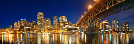 Vancouver False Creek at night with bridge and boat panorama.の写真素材