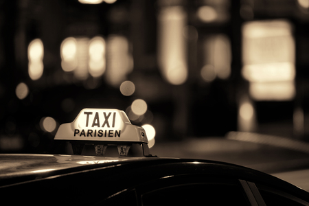 Taxi at night in Paris street bokehの写真素材