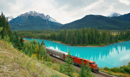 Cargo train and lake forest in Banff National Park in Canadaの写真素材