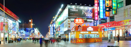 BEIJING, CHINA - APR 1: Wangfujing commercial street at night on April 1, 2013 in Beijing. It is one of the most famous shopping streets in the capital and the host of 280 famous Beijing brands storesの写真素材