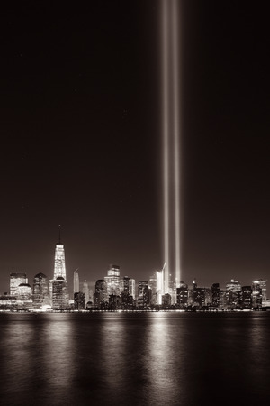 New York City downtown urban architecture at night and September 11 tribute light