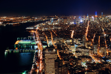 Rooftop night view of New York City midtown and Hudson River with urban skyscrapersの写真素材