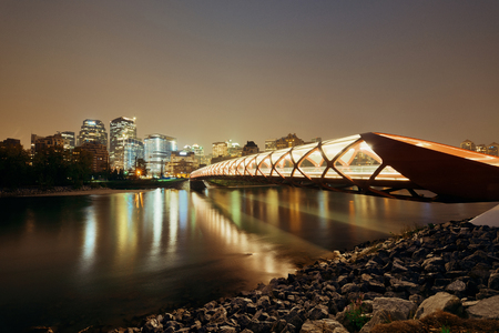 Calgary cityscape with Peace Bridge and downtown skyscrapers in Alberta at night, Canada.の写真素材