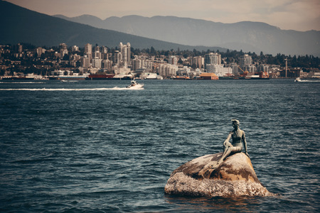 Girl in a Wetsuit sculpture in sea in Vancouver, Canada.の写真素材