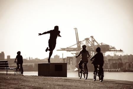 Stanley Park with sculpture of Harry Jerome and cargo crane in Vancouver, Canadaの写真素材