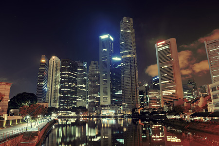 Singapore skyline at night with urban buildingsの写真素材