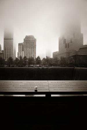 NEW YORK CITY - NOV 12: September 11 memorial in a foggy day on November 12, 2014 in Manhattan, New York City. With population of 8.4M, it is the most populous city in the United States.のeditorial素材