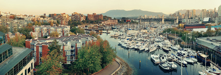 Vancouver harbor view with urban apartment buildings and bay boat in Canada.の写真素材